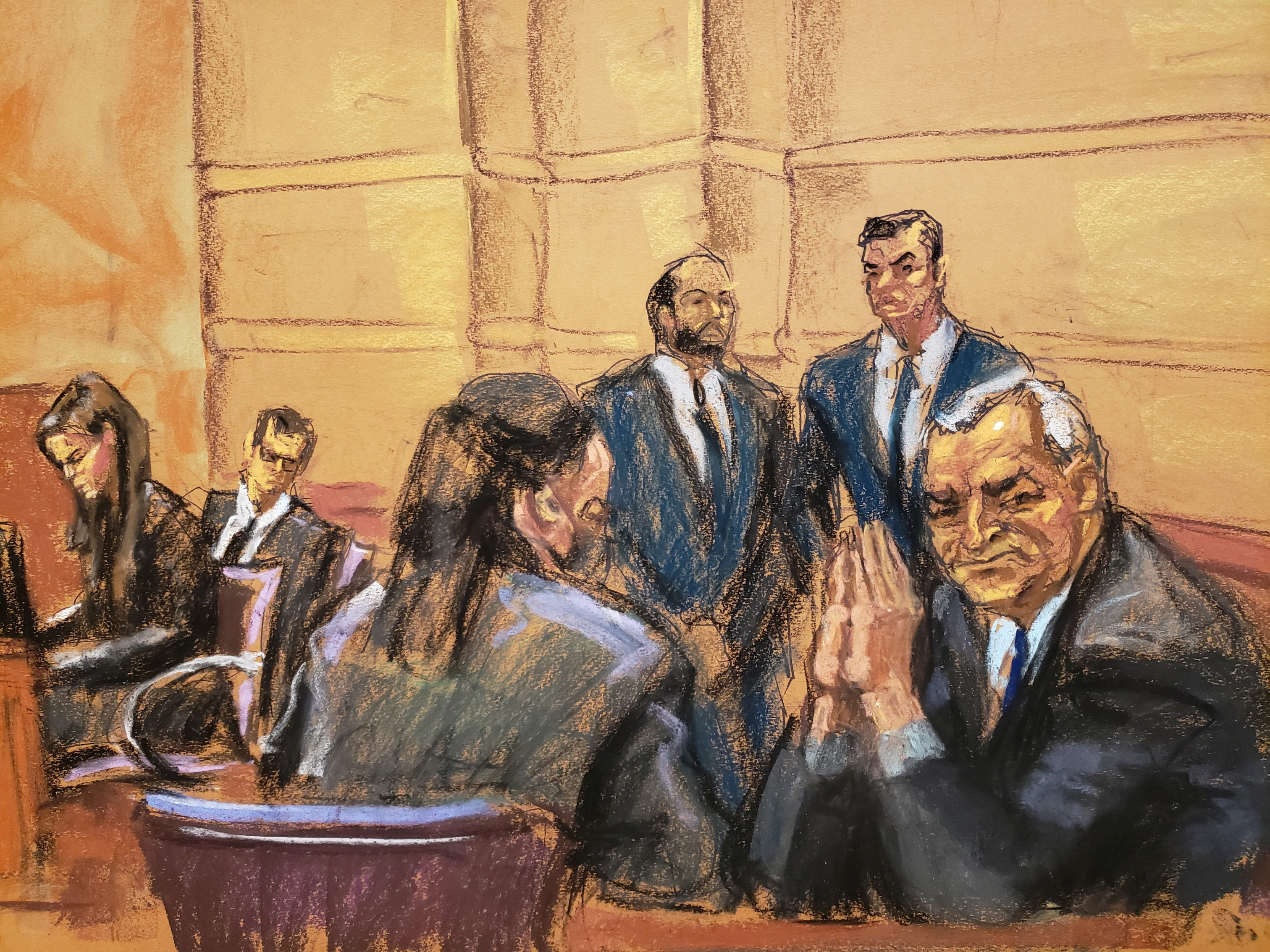 Mexico's former Public Security Minister Genaro Garcia Luna looks back at his wife seated in the audience during his trial on charges that he accepted millions of dollars to protect the powerful Sinaloa Cartel, once run by imprisoned drug lord Joaquin "El Chapo" Guzman, at a courthouse in New York City, U.S., January 30, 2023 in this courtroom sketch. REUTERS/Jane Rosenberg