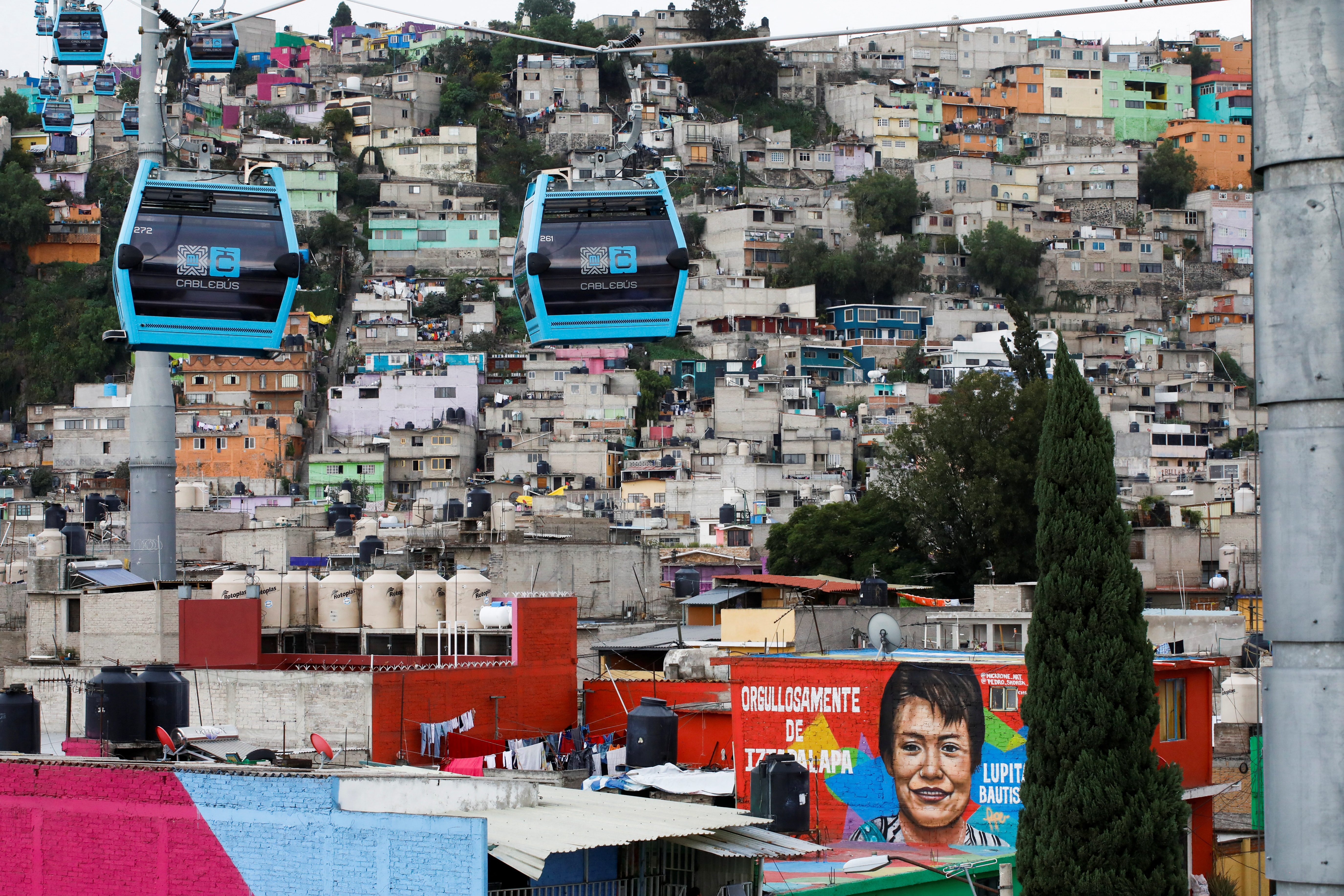A mural of boxer Guadalupe Bautista is seen close to the cable cars system dubbed the Cablebus in the Iztapalapa neighbourhood in Mexico City, Mexico October 20, 2022. REUTERS/Raquel Cunha