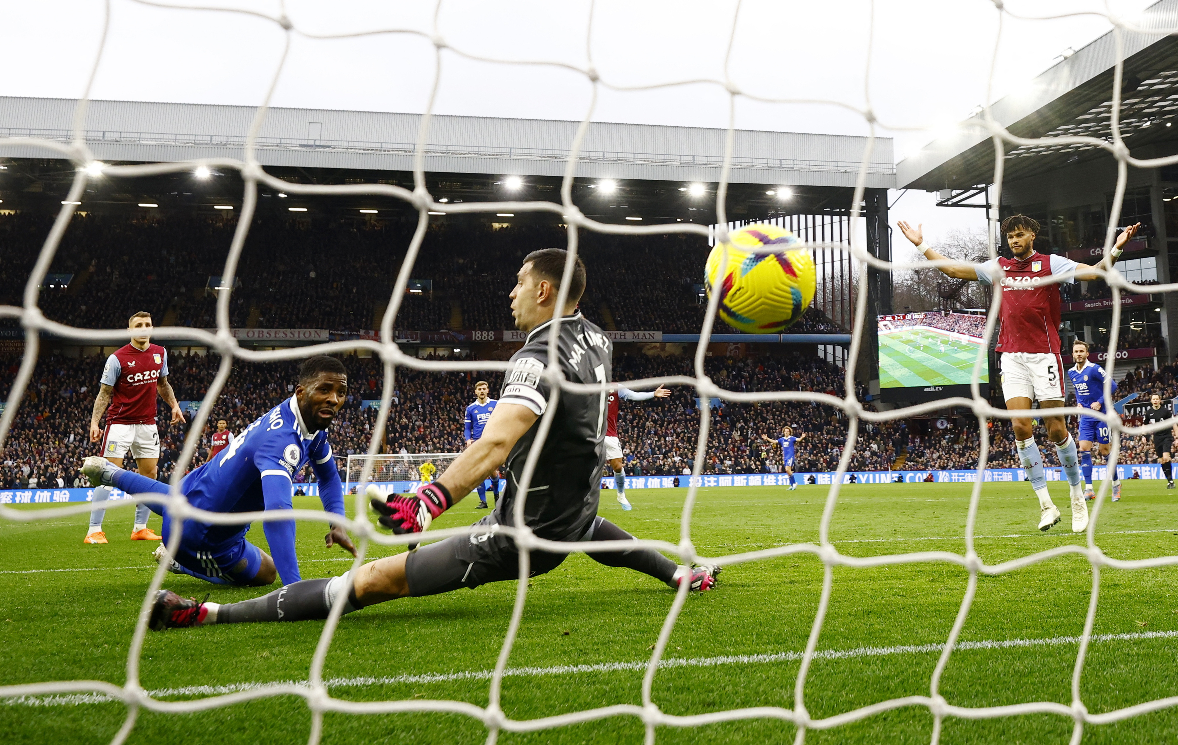 Soccer Football - Premier League - Aston Villa v Leicester City - Villa Park, Birmingham, Britain - February 4, 2023 Leicester City's Kelechi Iheanacho scores their second goal past Aston Villa's Emiliano Martinez Action Images via Reuters/John Sibley EDITORIAL USE ONLY. No use with unauthorized audio, video, data, fixture lists, club/league logos or 'live' services. Online in-match use limited to 75 images, no video emulation. No use in betting, games or single club /league/player publications. Please contact your account representative for further details.