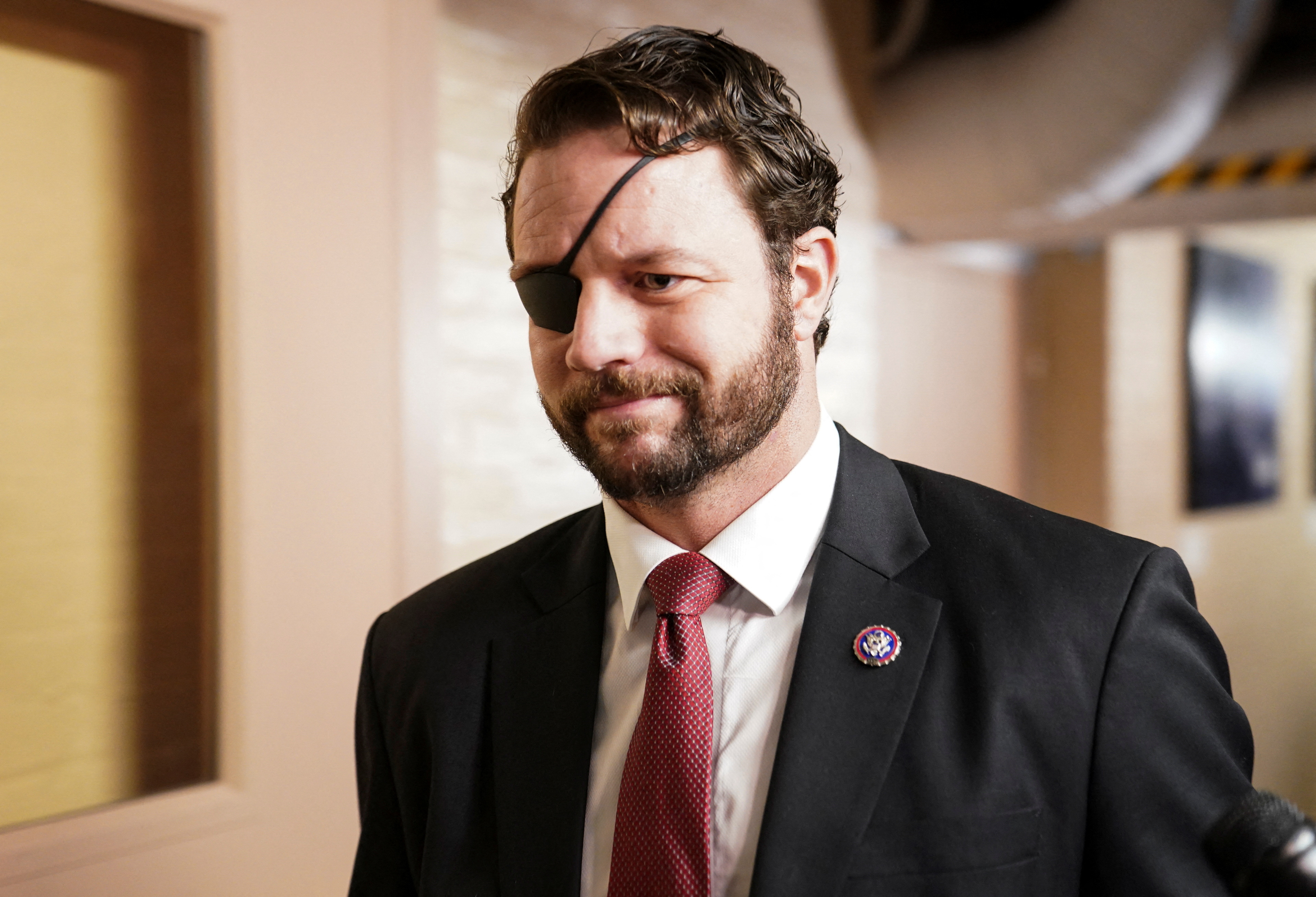 U.S. Rep. Dan Crenshaw (R-TX) walks to a House GOP Caucus meeting at the U.S. Capitol on the first day of the new Congress in Washington, U.S., January 3, 2023. REUTERS/Jon Cherry